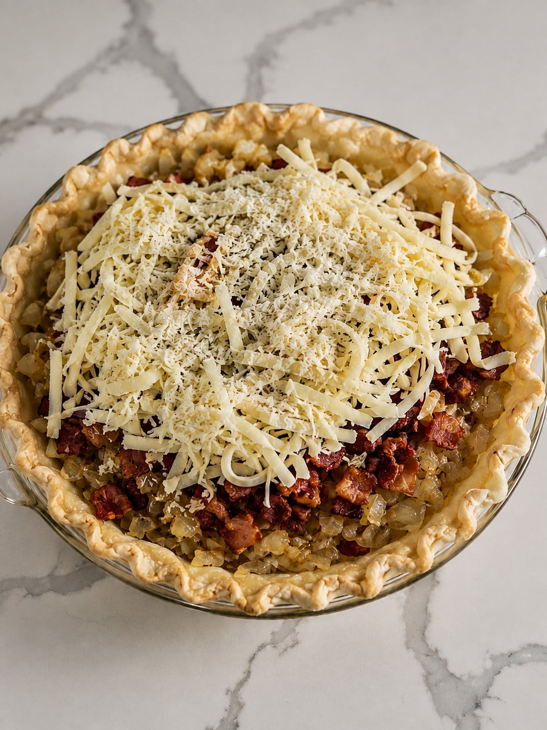 Blind-baked pie crust layered with sautéed onion, crisp bacon, Gruyère, and Parmesan.