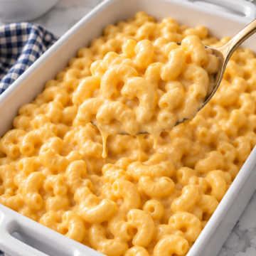 A spoonful of elbow macaroni coated in creamy three-cheese sauce.