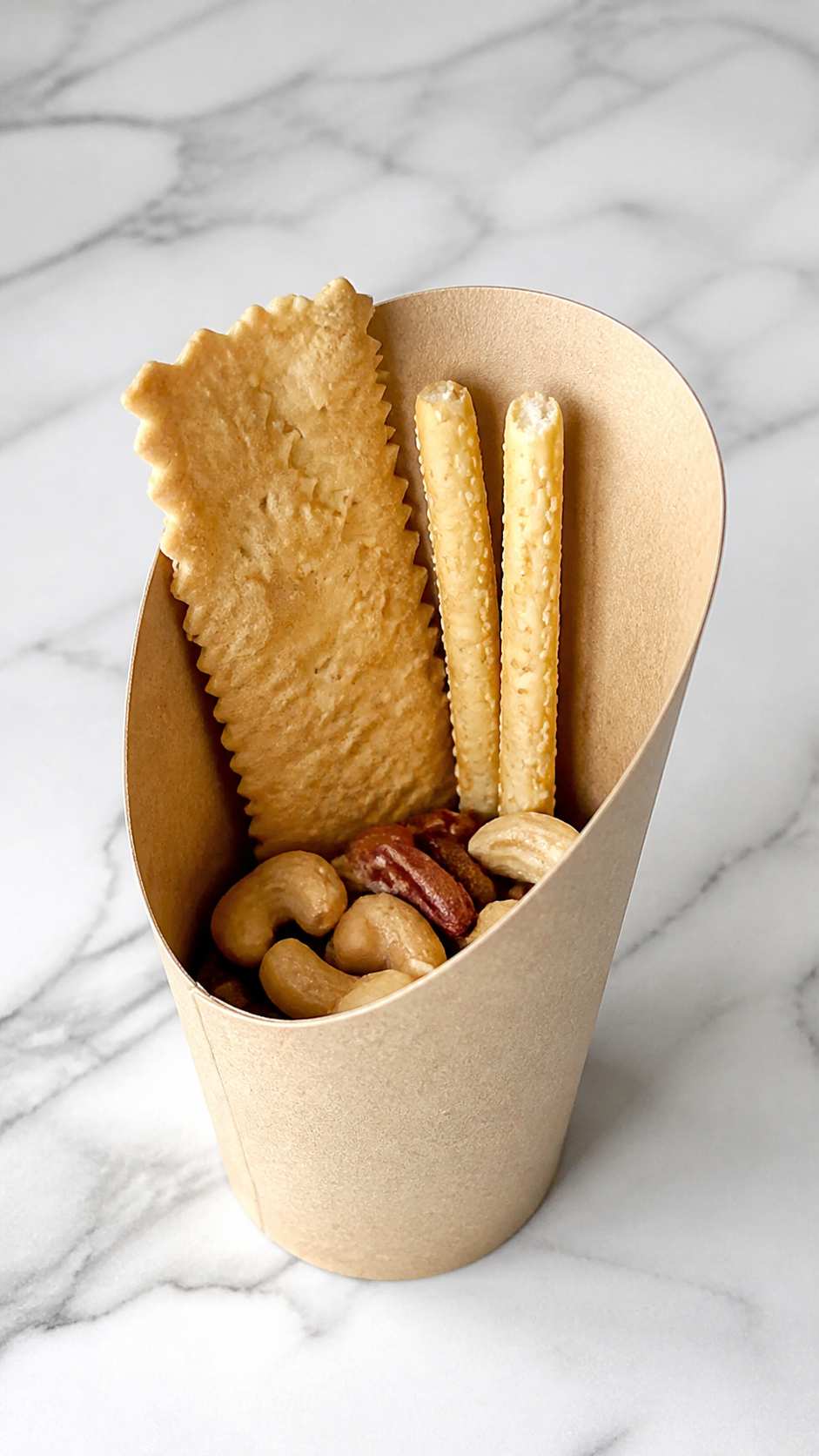 Flatbread crackers and halved breadsticks arranged toward the back of charcuterie cups.