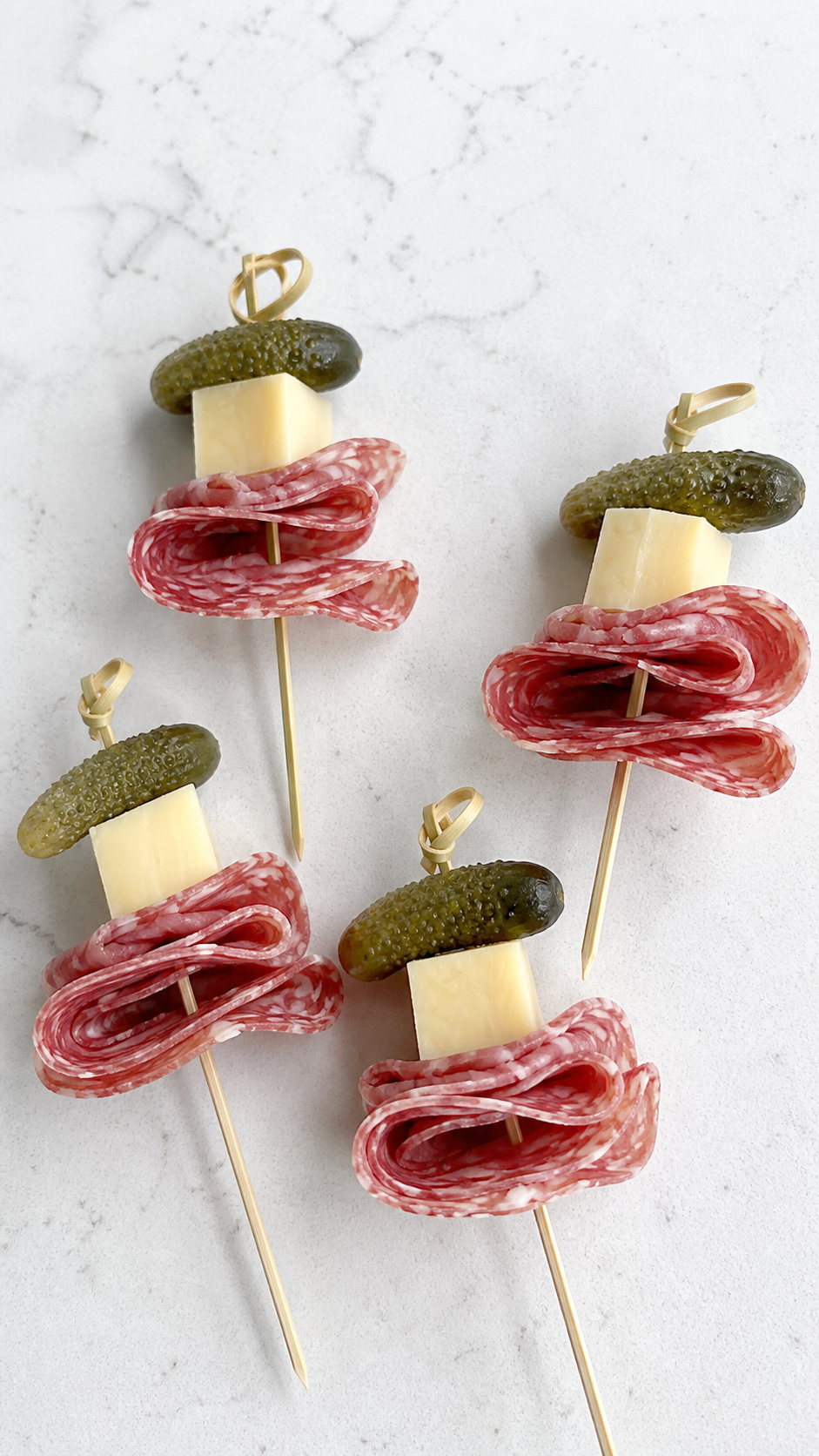 Salami, smoked Gouda, and dill gherkin skewers for individual charcuterie cups.