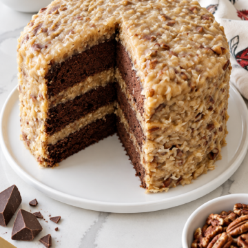 Three-layer German chocolate cake with coconut-pecan frosting covering the top and sides.