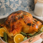 Herb butter roasted turkey in an oven bag, finished golden brown with fresh sage and lemon
