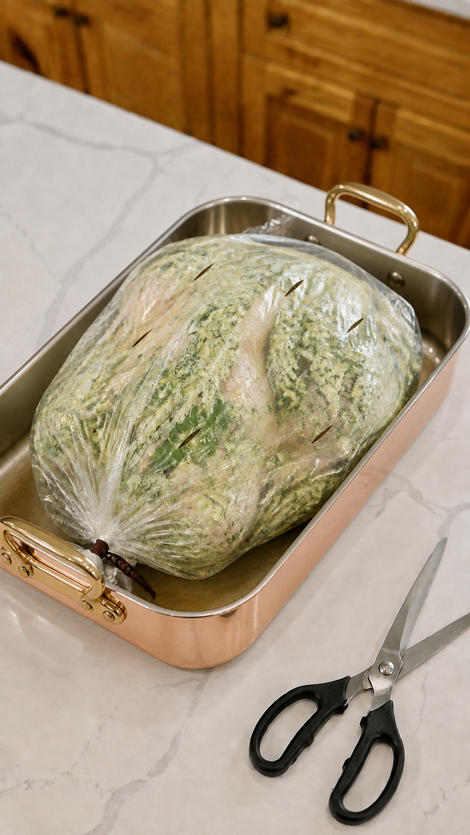 Herb butter turkey tied and vented inside an oven bag in a Mauviel copper and brass roasting pan