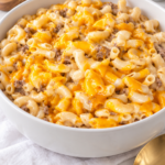 Homemade cheeseburger macaroni with ground beef and creamy cheddar sauce in a white serving bowl