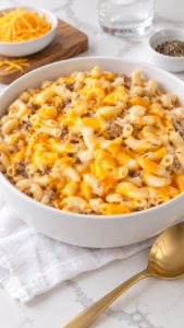 Homemade cheeseburger macaroni with ground beef and creamy cheddar sauce in a white serving bowl