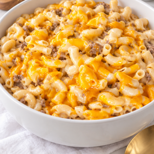 Homemade cheeseburger macaroni with ground beef and creamy cheddar sauce in a white serving bowl