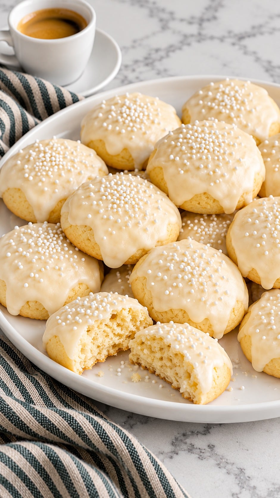 Finished Italian Christmas cookies topped with almond icing and white nonpareils.
