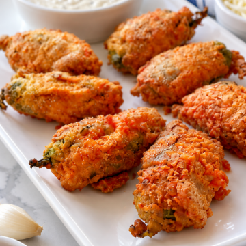 Close view of the crisp seasoned flour coating on fried scorpion tails.