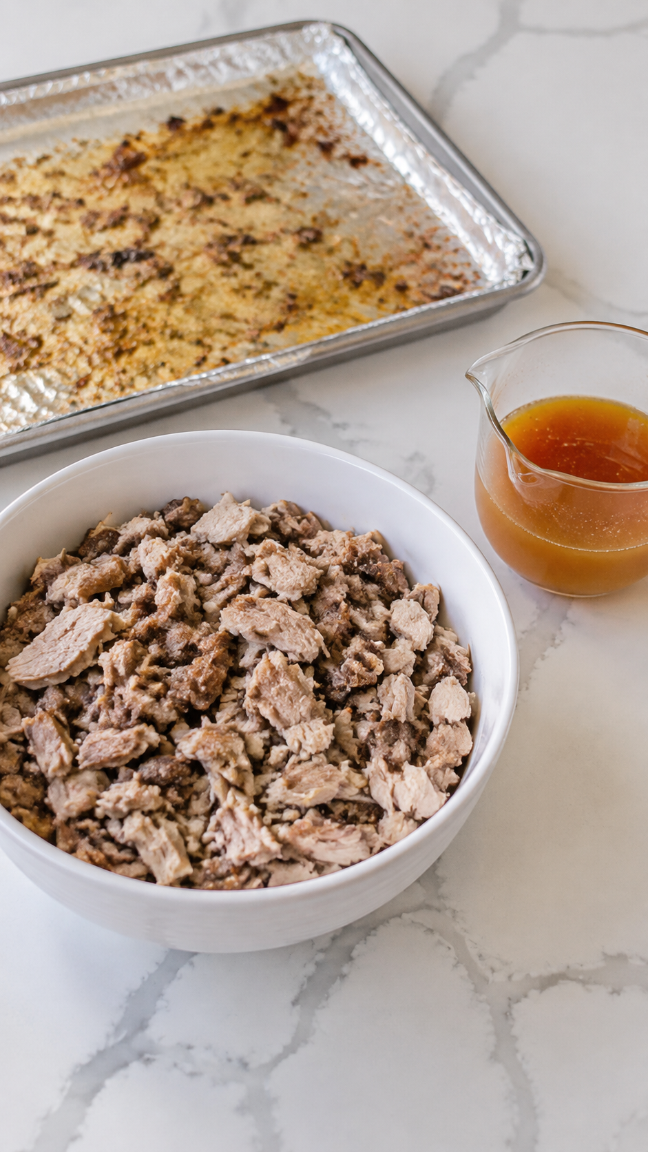 Chopped roasted turkey and reserved drippings ready for mixing