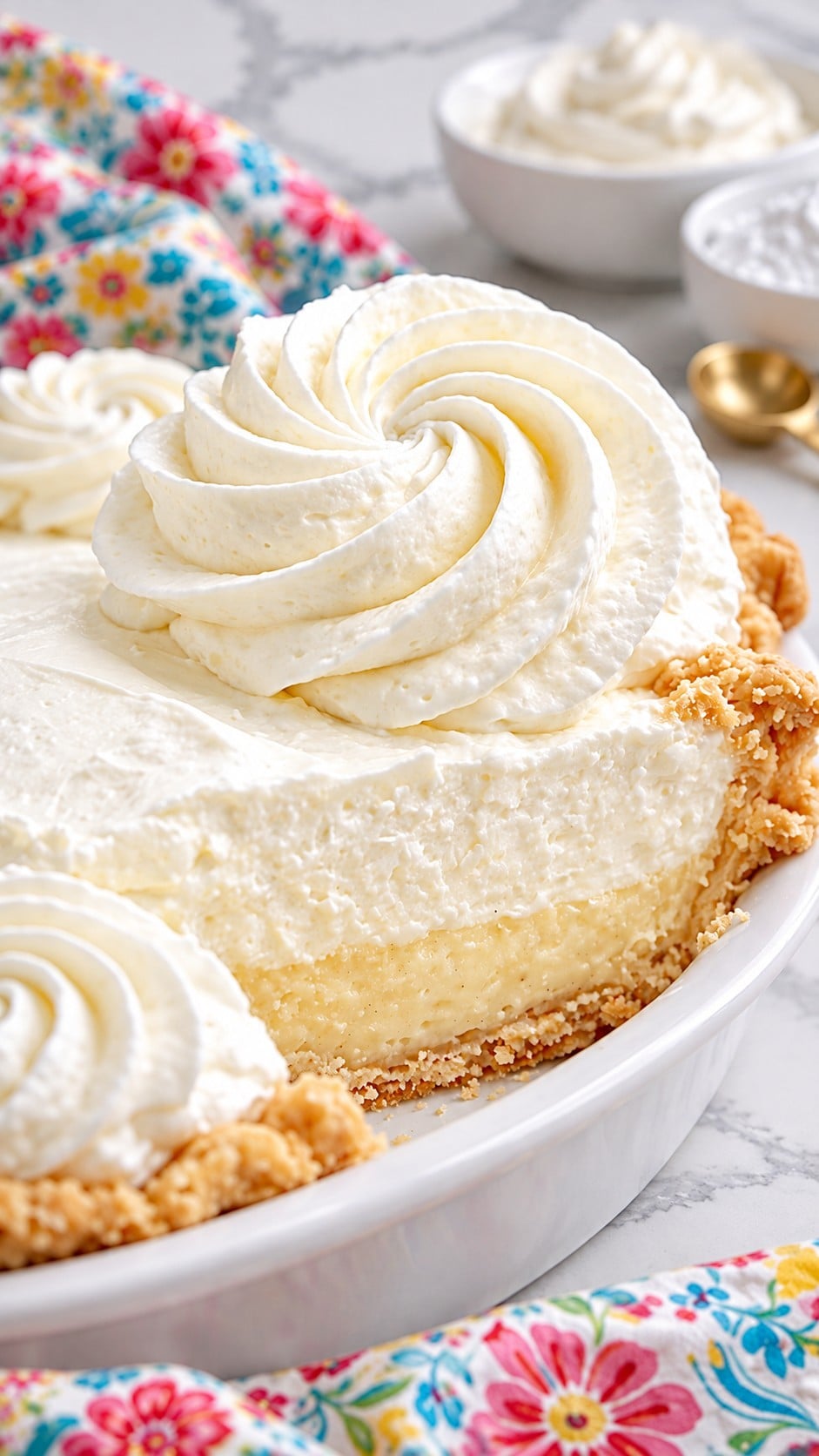Close-up of airy whipped cream and a piped rosette on a slice of pie.