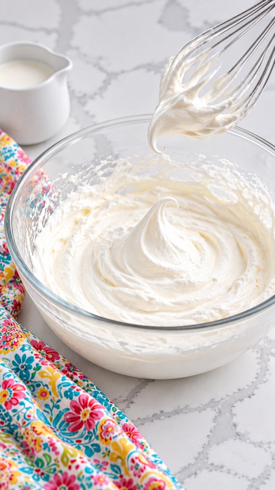 Whipped heavy cream at soft peaks with a tip that curls over.