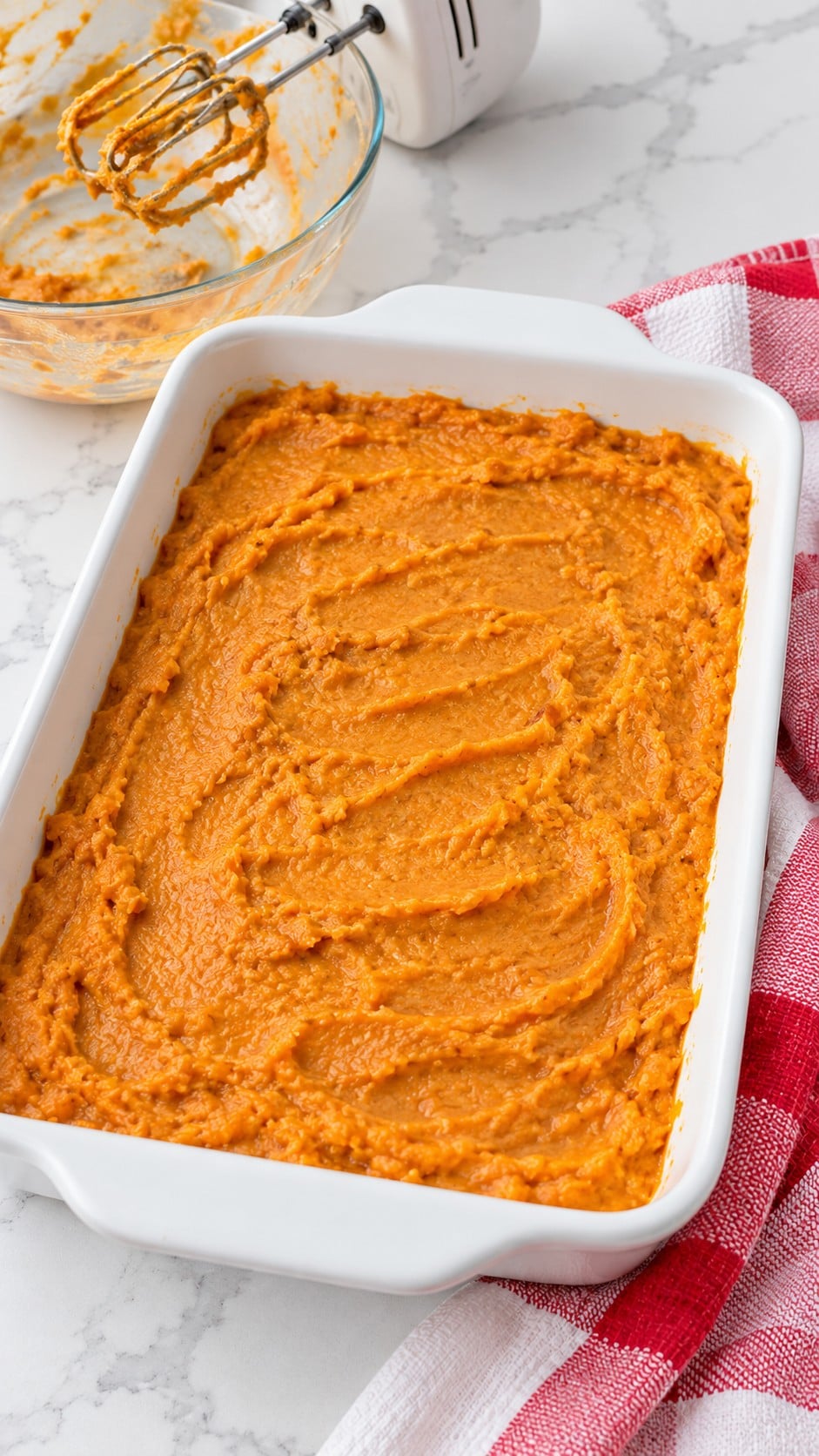 Smooth sweet potato filling spread in a baking dish