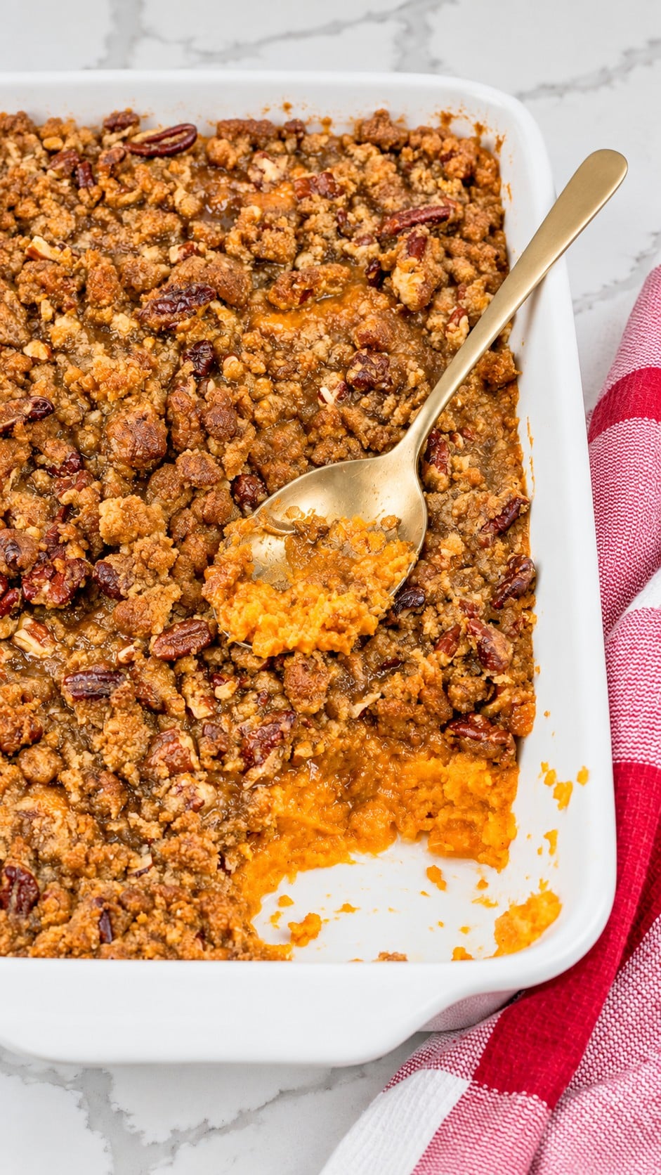 Baked sweet potato casserole resting with golden pecan topping