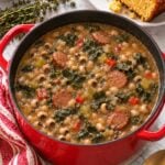 Homemade black-eyed pea soup with andouille and cooked collard greens served with cornbread