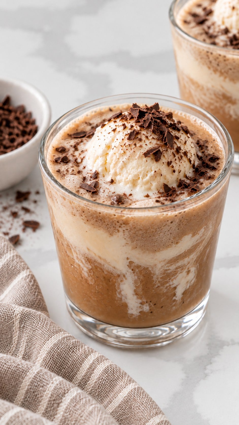 Close view of melting vanilla ice cream in tan coffee punch