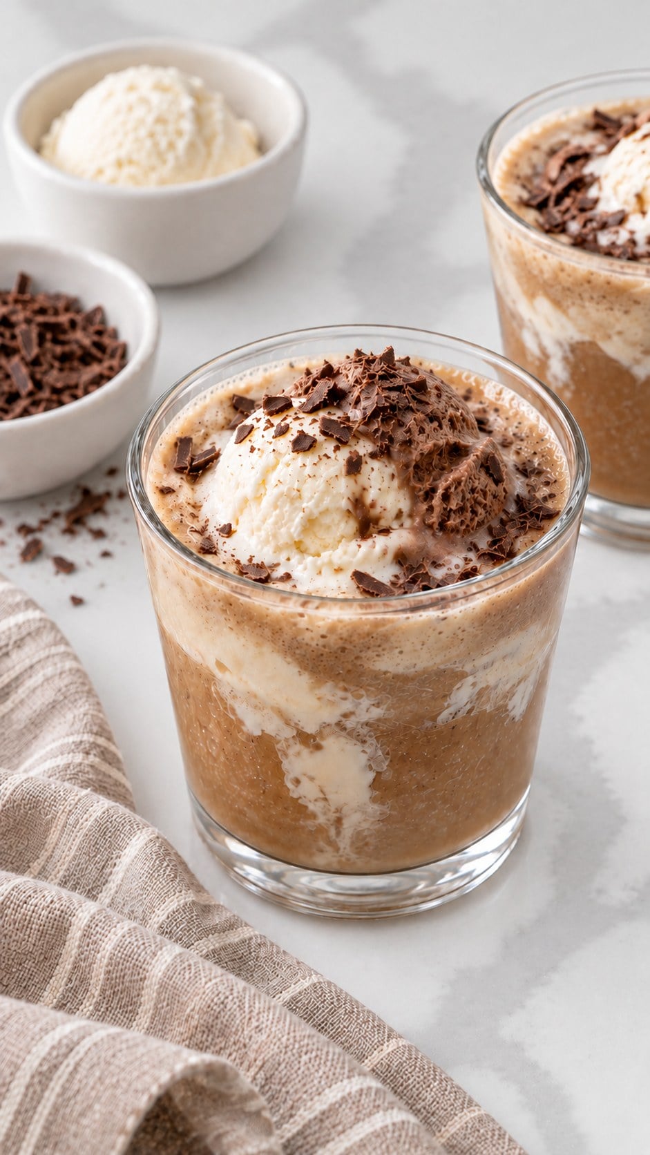 Finished creamy coffee punch with vanilla and chocolate ice cream and optional chocolate shavings