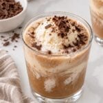 Coffee punch with vanilla ice cream and chocolate shavings in a clear glass