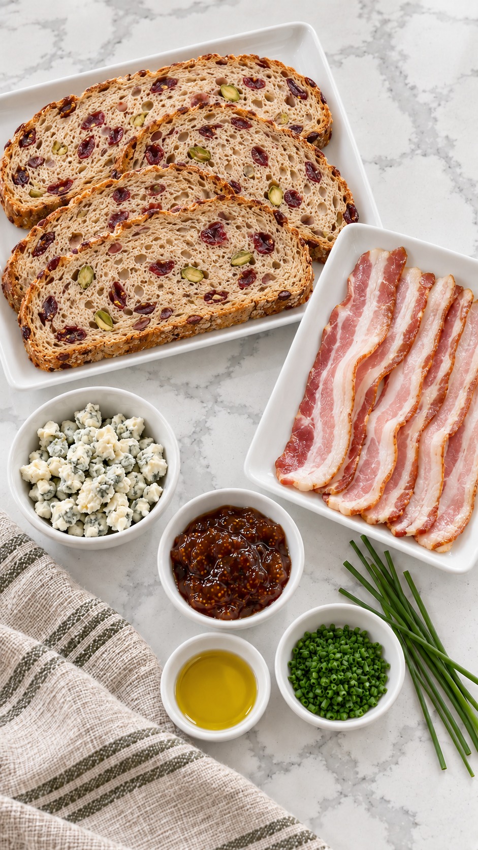 Cranberry-pistachio bread, olive oil, fig jam, bacon, blue cheese, and fresh chives for crostini.