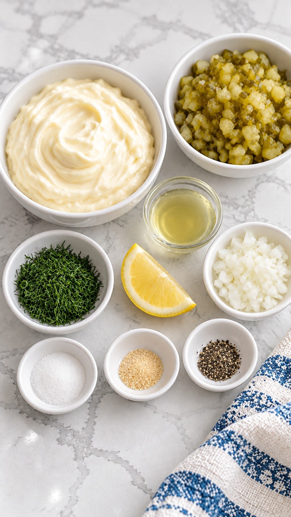 Mayonnaise, chopped dill pickles, pickle juice, sweet onion, fresh dill, lemon juice, sugar, garlic powder, and black pepper.
