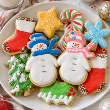 Decorated vanilla almond sugar cookie cutouts on a white platter