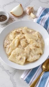 Southern chicken and dumplings with flat rolled dumplings and chicken in creamy broth.